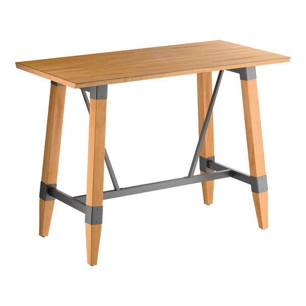 A rectangular bar-height table with a honey-colored wooden top and legs, featuring gray metal support brackets and crossbars for added stability.