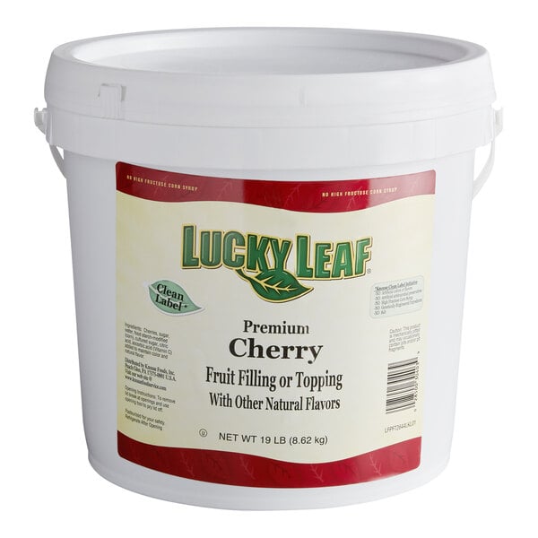 A large white plastic pail with a label for Lucky Leaf Premium Cherry Fruit Filling & Topping.