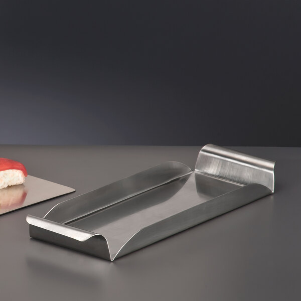 A World Tableware brushed metal tray with rolled handles holding sushi.