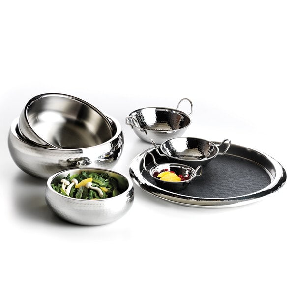 A group of Libbey Sonoran stainless steel bowls on a table filled with fruit and berries.