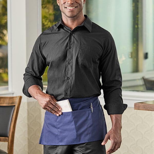 A man wearing a black Henry Segal dress shirt and black pants.
