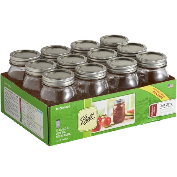 A box of 12 Ball glass canning jars with silver metal lids and bands.