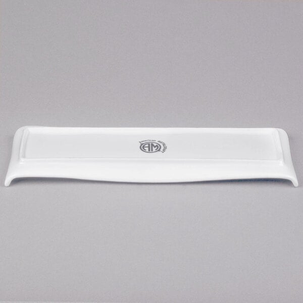 A white rectangular American Metalcraft porcelain serving platter with a curved edge and a logo on it.