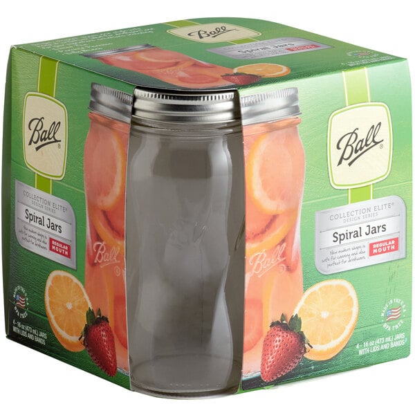 A Ball glass jar with a silver metal lid filled with orange juice.