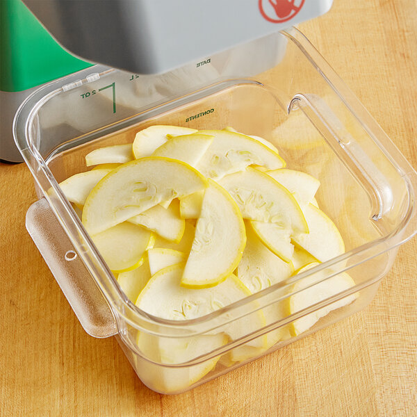 A container of sliced yellow squash in a food processor with a AvaMix 1/8" Slicing Disc.