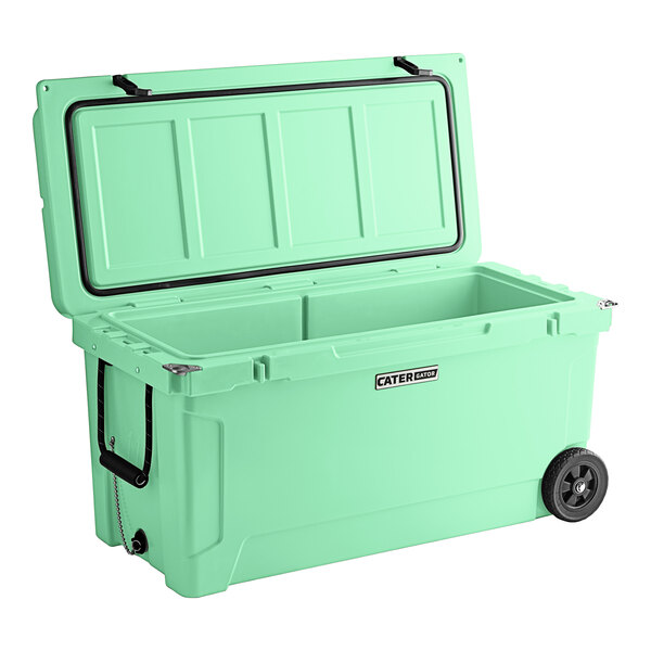 A seafoam green CaterGator outdoor cooler with wheels.