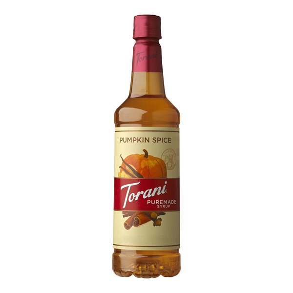 A Torani Pumpkin Spice flavoring syrup plastic bottle on a table.