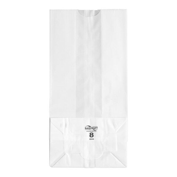A white paper bag with a flat bottom and printed text near the base.