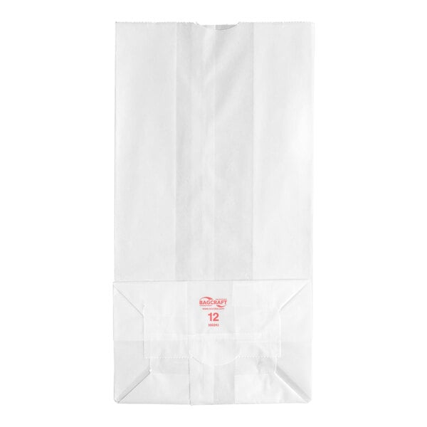 A white paper bag with a flat bottom and red printed text near the base.