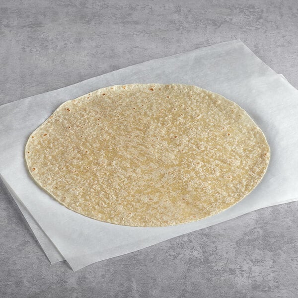 A Mission 12" flour tortilla on a white surface.