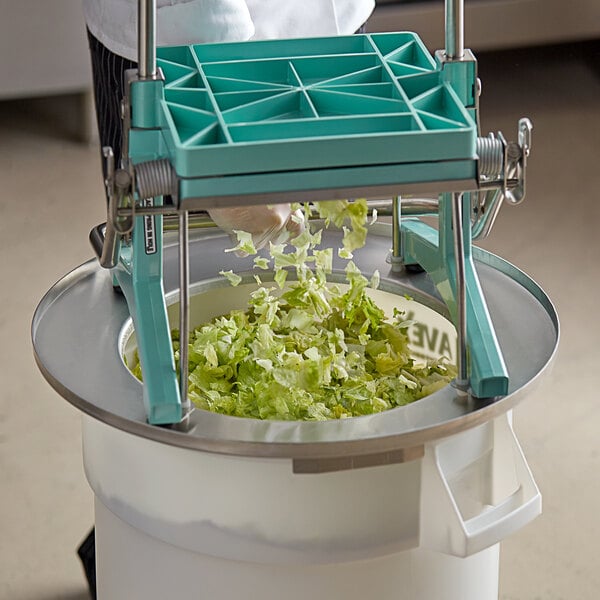 a hand pouring lettuce into a container