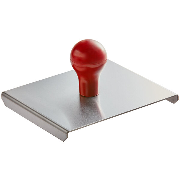 A red rubber ball on a metal plate with a red Prince Castle logo.