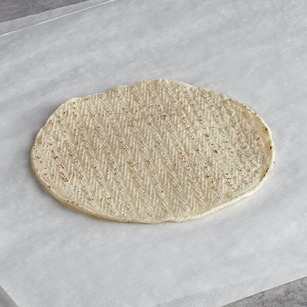 A Mission white corn tortilla on a white surface.