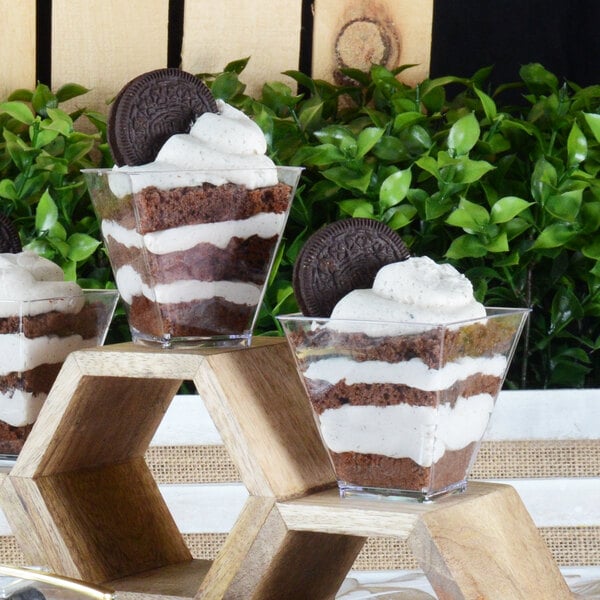 A table with Fineline Tiny Temptations twisted cups filled with chocolate and Oreo desserts.