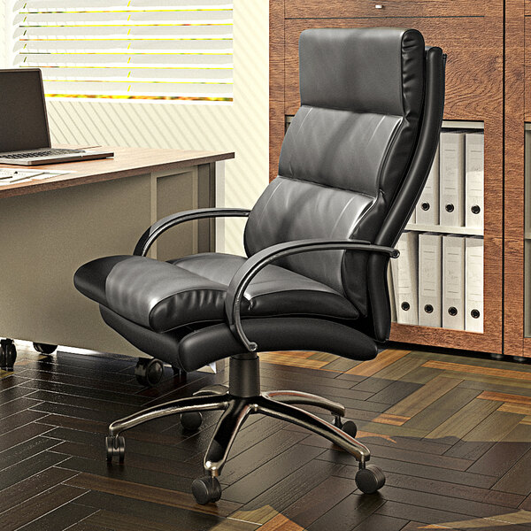 A black leather Boss office chair in front of a desk with a laptop.