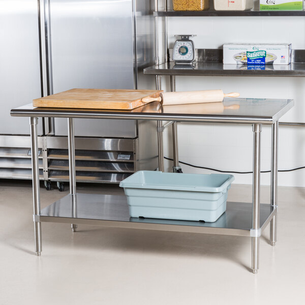 An Advance Tabco stainless steel work table with an undershelf.