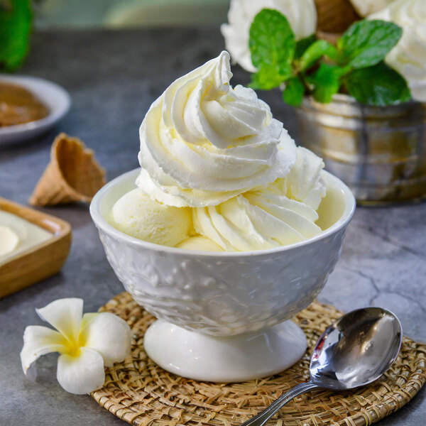 A bowl of Chef's Companion vanilla soft serve ice cream with white swirls.
