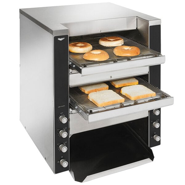 A Vollrath dual conveyor bread toaster with two pieces of bread in it.