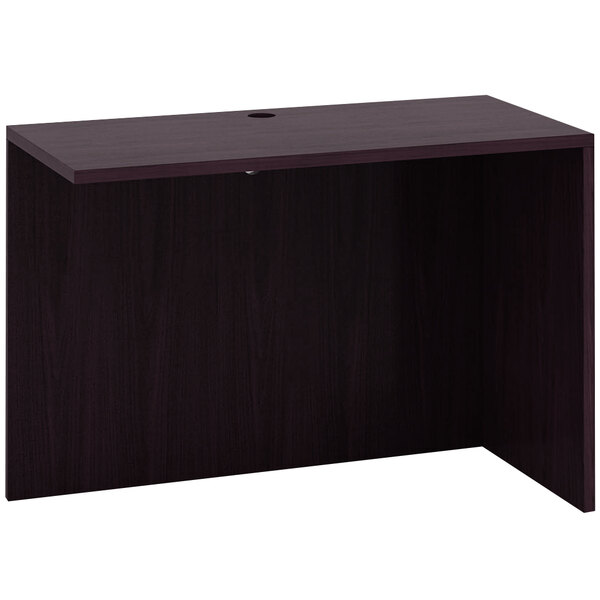 A dark wood Boss mocha laminate reversible return desk.