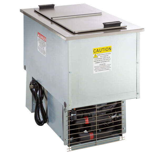 A Delfield drop-in freezer with stainless steel lids over vents.