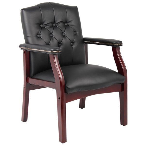 A black leather Boss Ivy League executive guest chair with wooden legs.