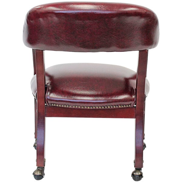 A Boss burgundy vinyl Captain's chair with wheels and a cushioned backrest.