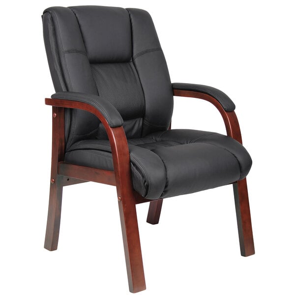 a black leather chair with wooden arms