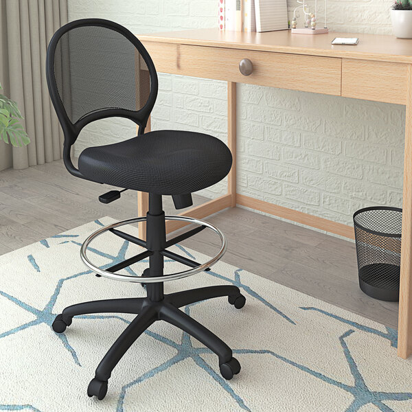 A Boss black mesh drafting stool with a metal ring on the back.
