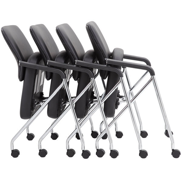 A group of four black Boss CaressoftPlus office chairs with chrome frames.