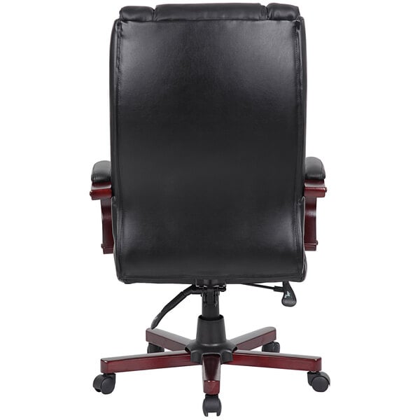 The back of a black leather Boss office chair with a mahogany finish.
