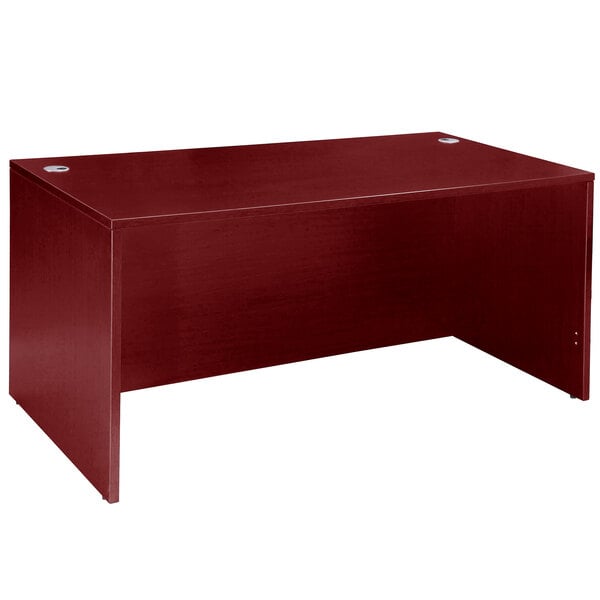 A mahogany Boss desk shell on a table.