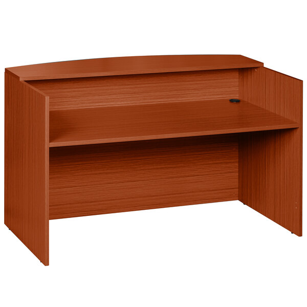 A brown Boss cherry laminate reception desk with a shelf.