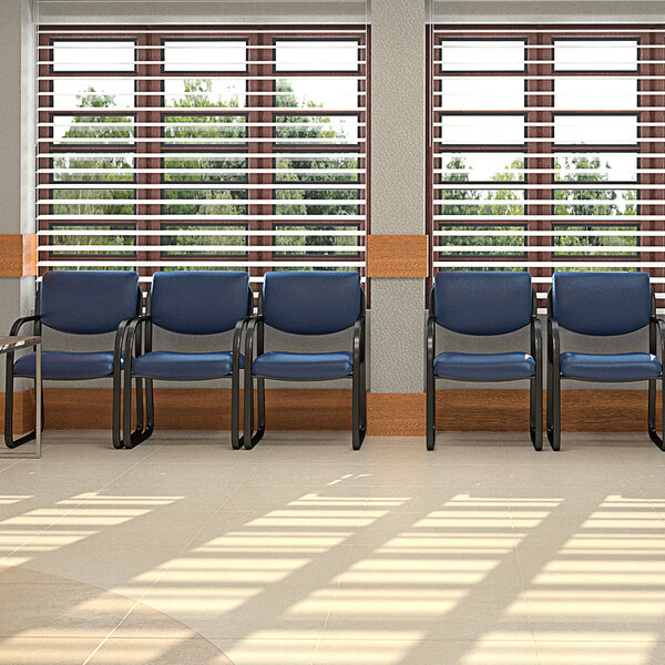 A row of Boss blue fabric guest chairs with black metal legs.