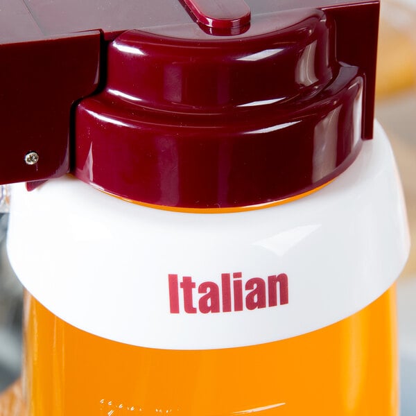 A white plastic Tablecraft salad dressing dispenser with maroon lettering on the collar and a red lid.