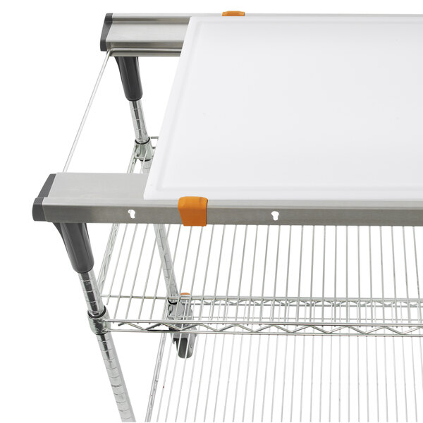 A white cutting board on a metal shelf.