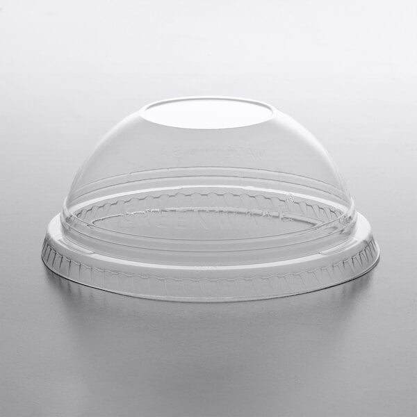 A clear plastic Fabri-Kal dome lid on a clear plastic cup.