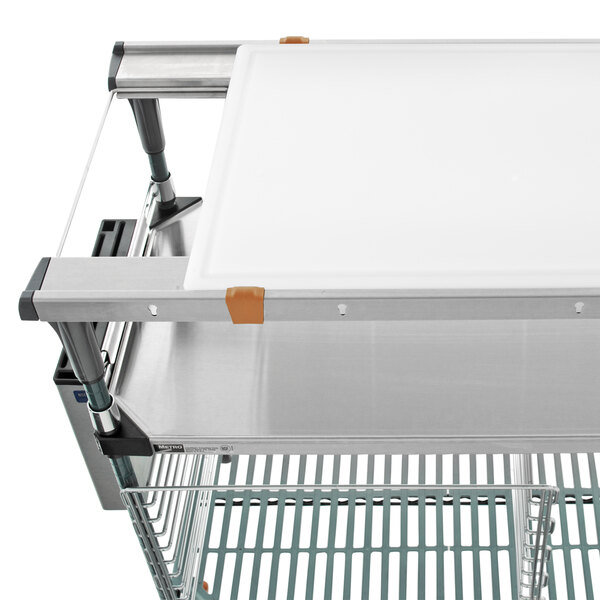 a white cutting board on a metal cart