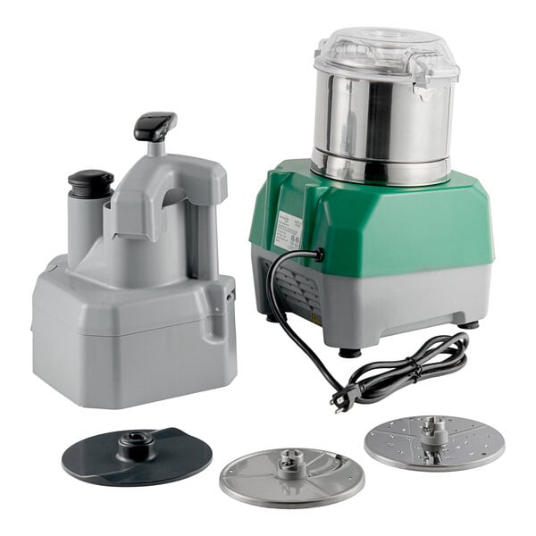 A commercial combination food processor with a stainless steel bowl, continuous feed attachment, and multiple discs.