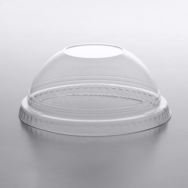 A clear plastic dome lid on a clear plastic cup.