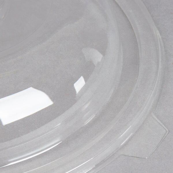A clear plastic Fineline dome lid on a clear plastic bowl.