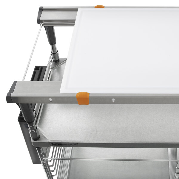 Metro PrepMate MultiStation with galvanized shelving and a white cutting board on top.