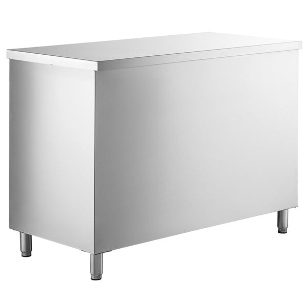 A Regency stainless steel table with sliding doors, a drawer, and a midshelf.