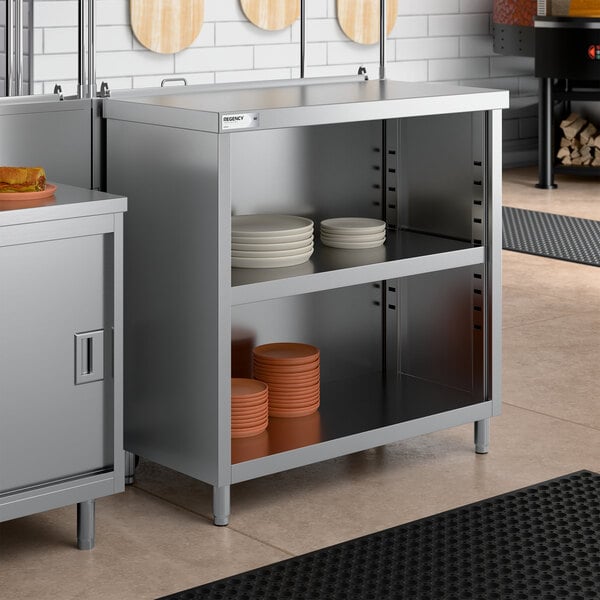 A stainless steel dish cabinet with an adjustable midshelf, holding stacks of plates.