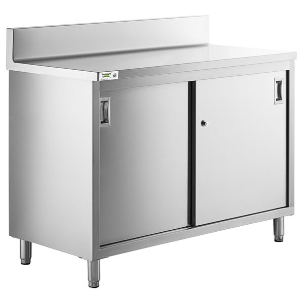 A Regency stainless steel enclosed base table with sliding doors and a midshelf.