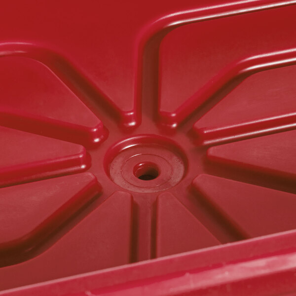 A red plastic Cambro container with a hole in the bottom.