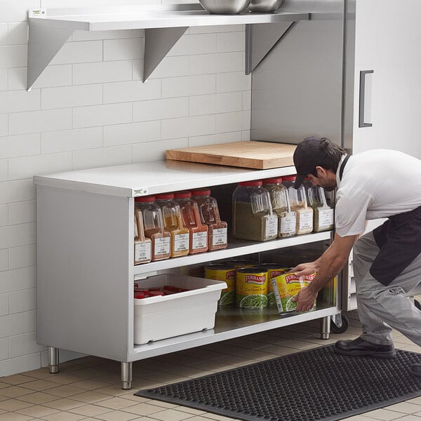 a person putting food into a shelf