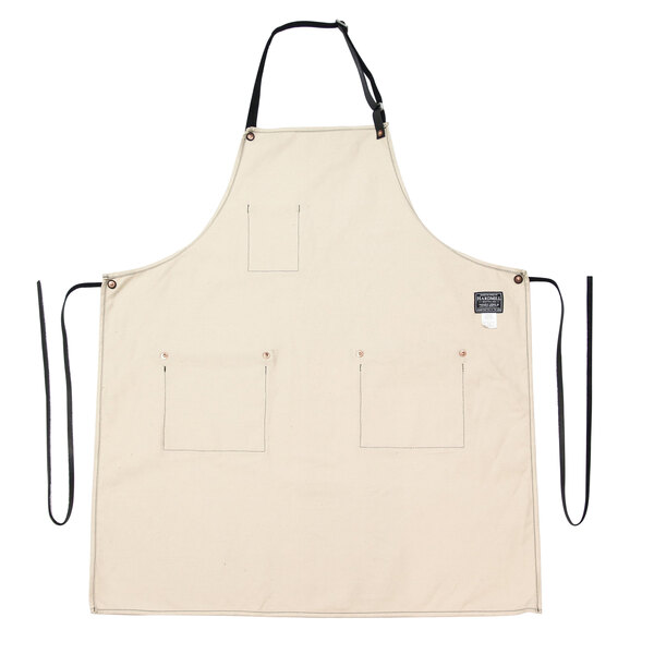 A natural canvas apron with black straps.