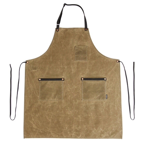A Hardmill Field Tan waxed canvas bib apron with black leather pockets and straps.