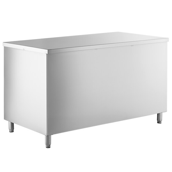 A white rectangular object with stainless steel legs and a silver shelf inside.