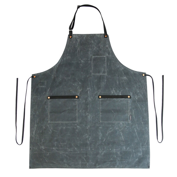 A grey Hardmill apron with black straps hanging on a counter.